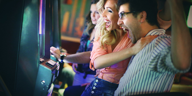 Photo of cheering couple at a slot machine